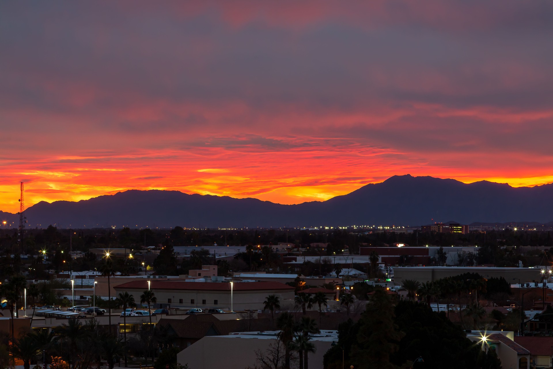 Warm red sunset with stormy clouds over Phoenix, AZ
